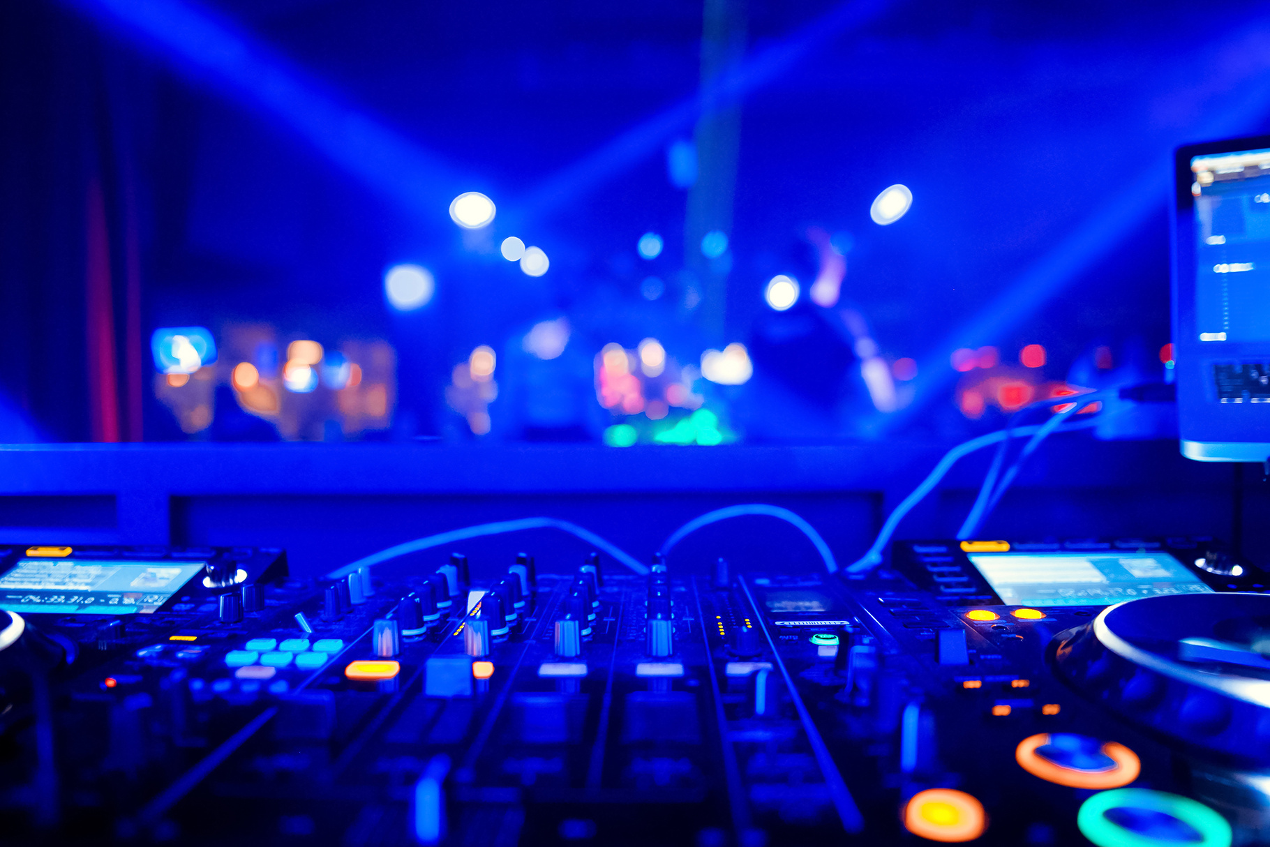 DJ playing music on light background